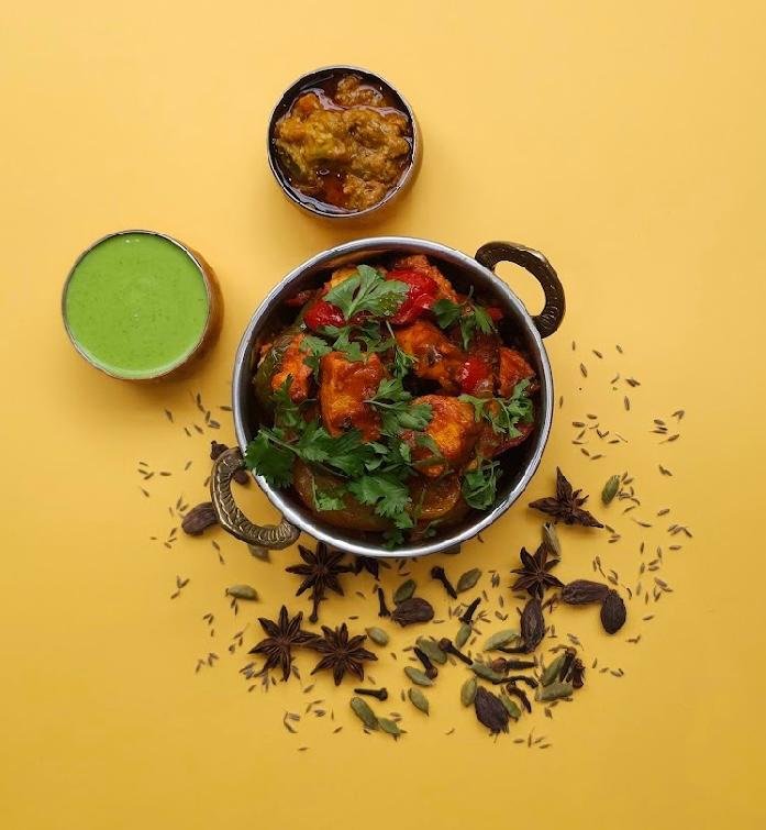 Authentic Indian chicken curry served with green chutney